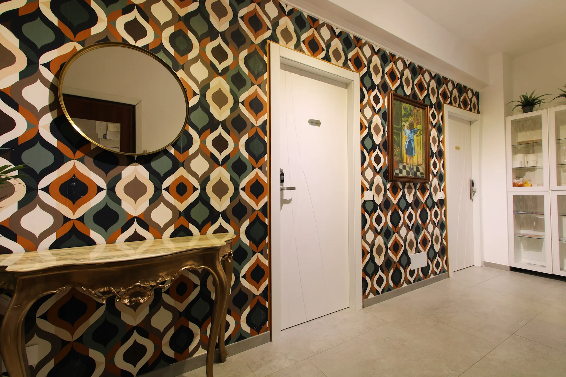 Ingresso YOU Rhome in Garbatella con carta da parati anni '70 e consolle vintage — boutique BnB Roma sud