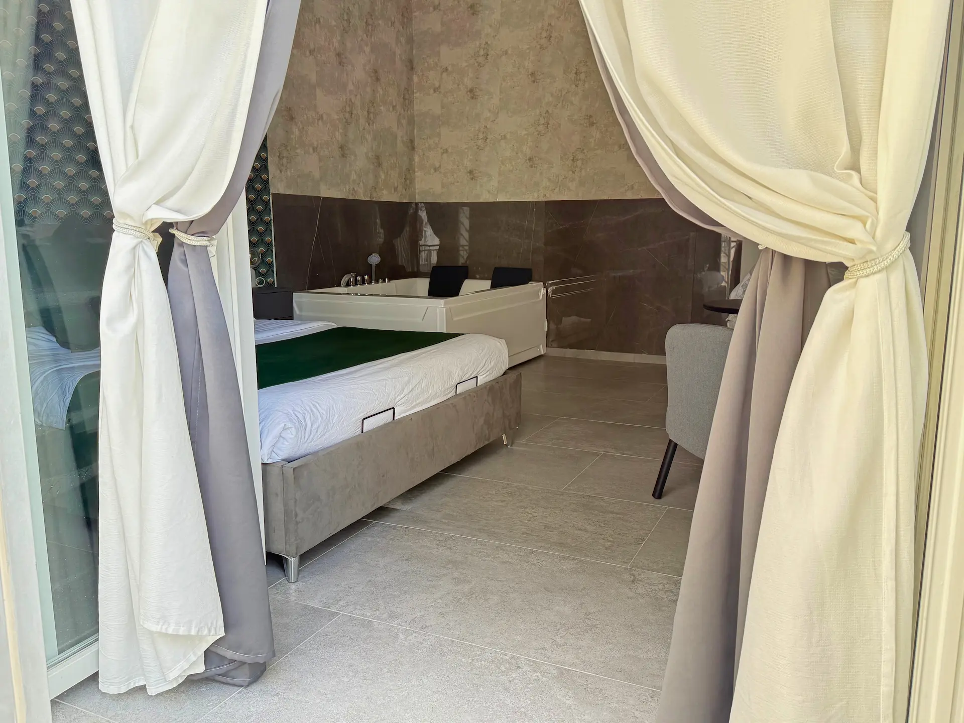 Suite Relax Vibes con vasca idromassaggio doppia rettangolare, LED verde sotto al letto e carta da parati art déco verde-oro — YOU Rhome Garbatella, boutique BnB Roma